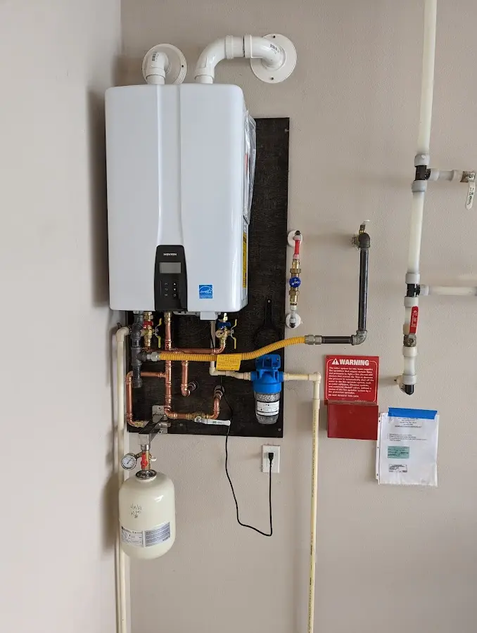 Professional plumber installing copper piping in a Forest Grove home